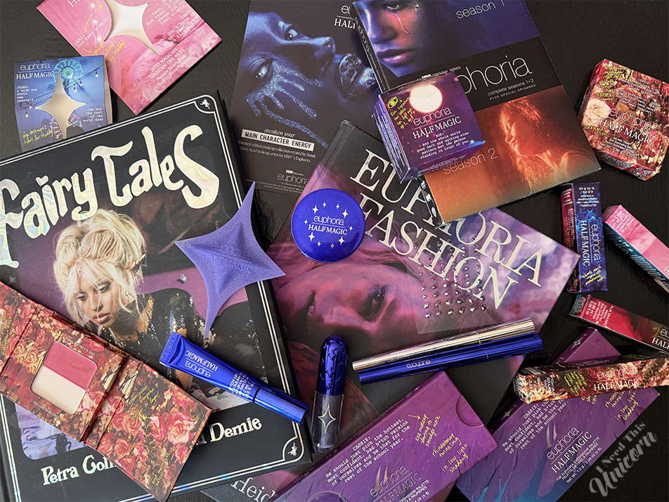 Euphoria-inspired beauty flatlay with Half Magic makeup, Petra Collins books, Fairy Tales magazine, glitter cosmetics, and HBO Euphoria collector items.