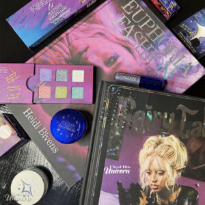 Euphoria-inspired beauty flatlay with Half Magic makeup, Petra Collins books, Fairy Tales magazine, glitter cosmetics, and HBO Euphoria collector items.