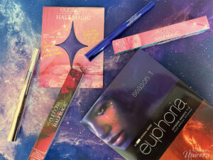 Half Magic Beauty x Euphoria makeup products styled with the Euphoria Season 1 DVD, including blue eyeliner, face gems, and glitter makeup inspired by the HBO series.