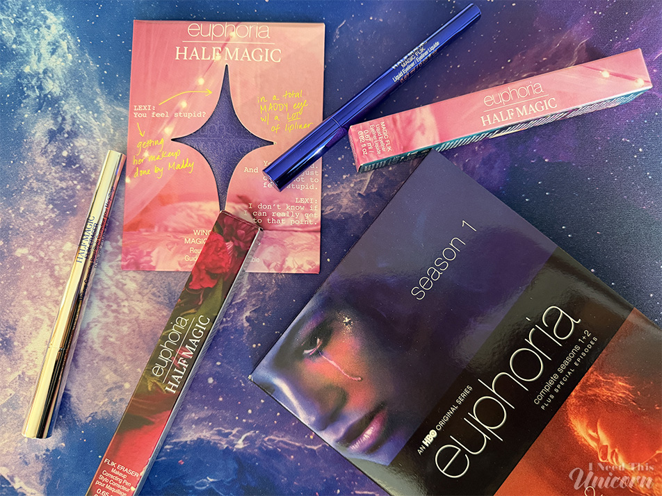 Half Magic Beauty x Euphoria makeup products styled with the Euphoria Season 1 DVD, including blue eyeliner, face gems, and glitter makeup inspired by the HBO series.