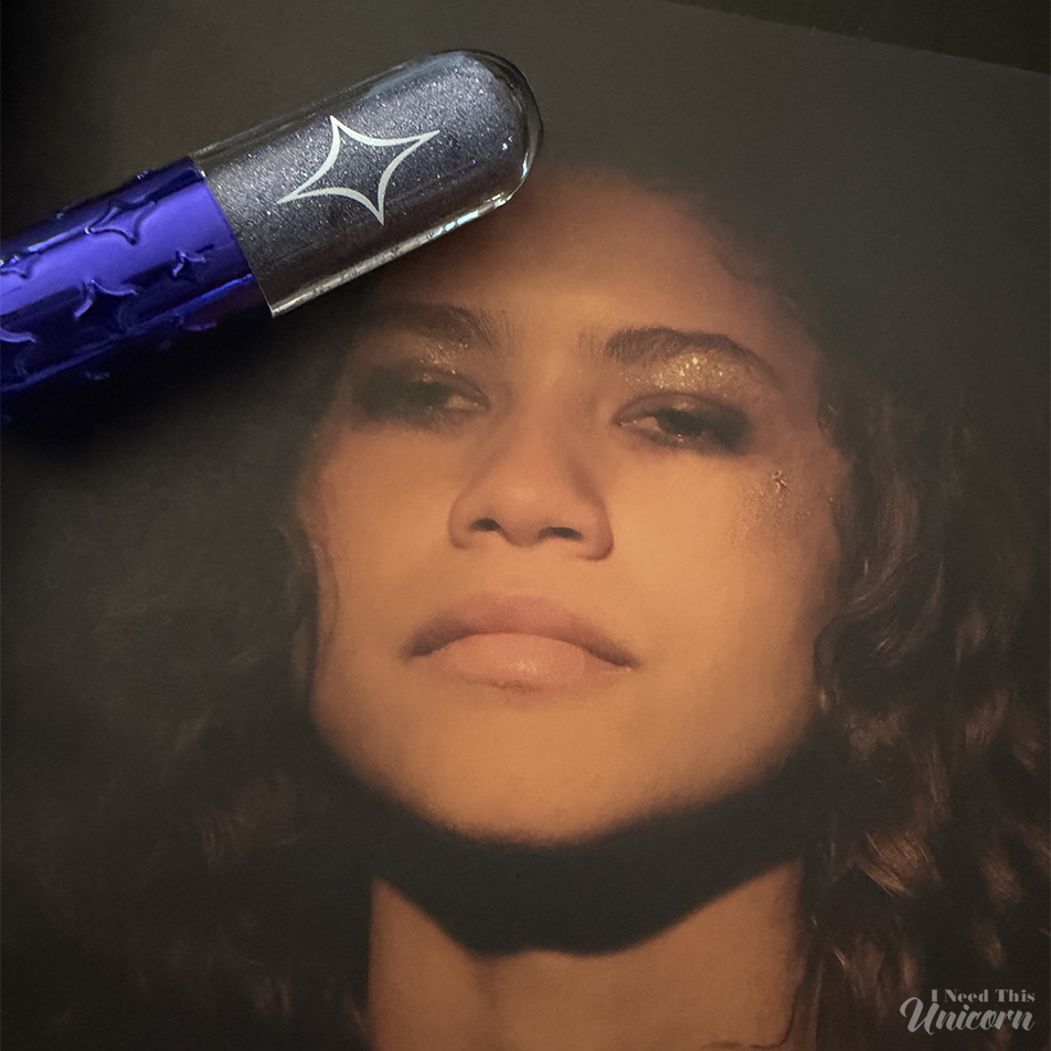 Half Magic Euphoria Glitter Pill in Glitter Tears pictured with a still of Rue Bennett wearing glitter, from the book Euphoria Fashion by Heidi Bivens
