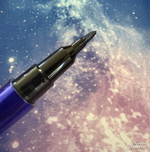 Half Magic Euphoria Magic Filk Eyeliner pictured on a galaxy background