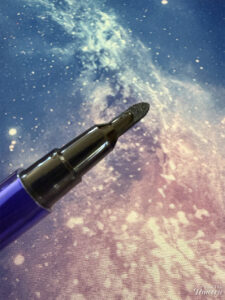 Half Magic Euphoria Magic Filk Eyeliner pictured on a galaxy background