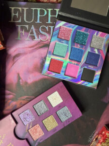 Euphoria palettes by Queen Cosmetics and Half Magic Beauty, pictured on Euphoria Fashion book