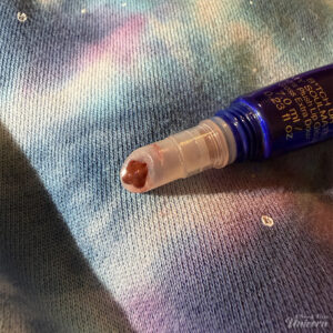 Half Magic Euphoria B*tch You’re My Soulmate Extra Plush Lip Gloss against a galaxy background. Open to show color.