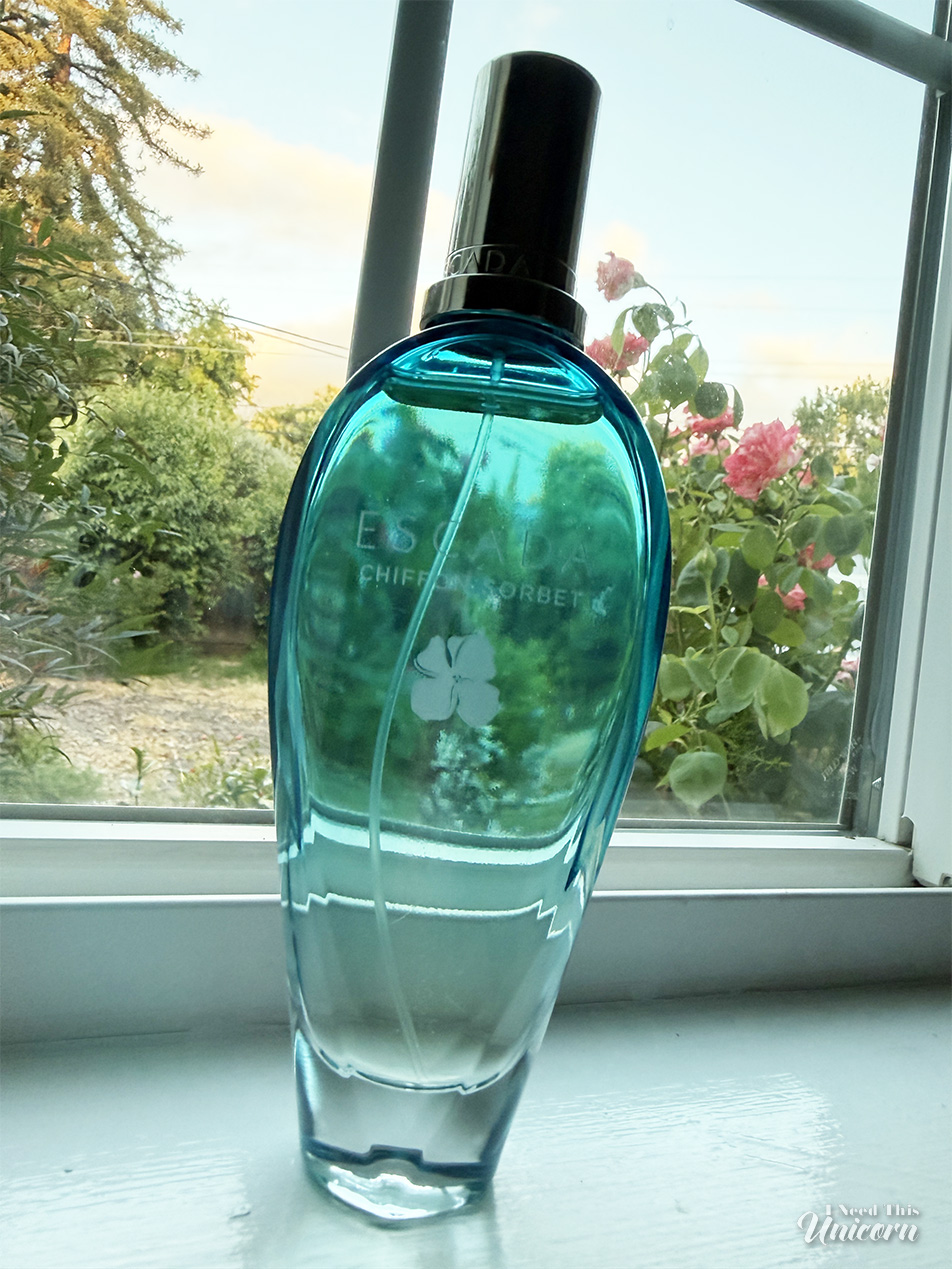 Aqua bottle of Escada's Chiffon Sorbet sitting on a window sill