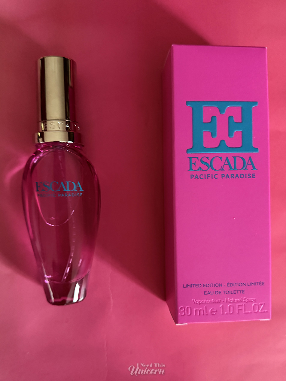 Bottle of the new repromoted Escada Pacific Paradise fragrance in the new smooth pink bottle and new florescent pink box with bright blue lettering.