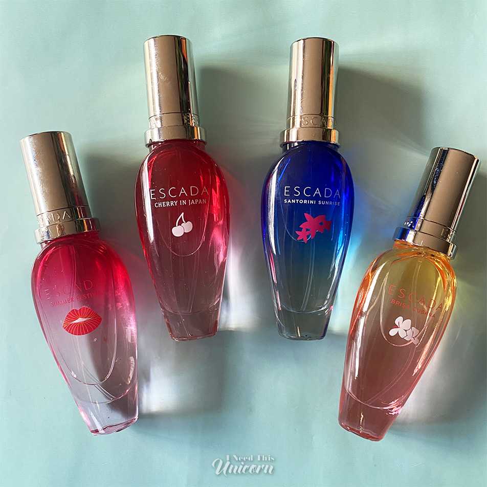 Bottles of Summer Festival, Cherry In Japan, Santorini Sunrise and Brisa Cubana on a mint background