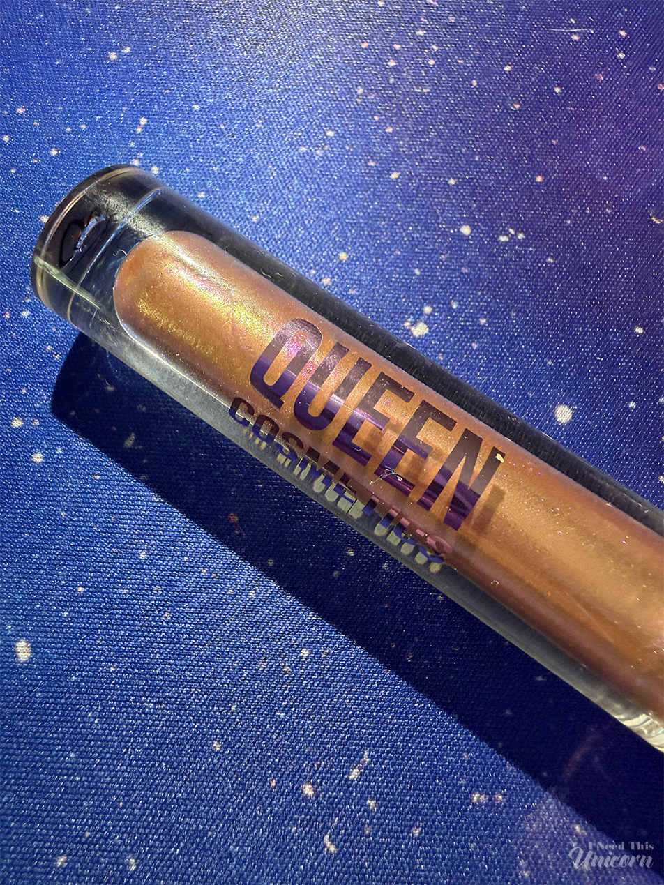 Queen Cosmetics Tester Diamond Shimmer Glosses | I Need This Unicorn Closeup detail shot of Queen Cosmetics Tester #3, with it's gold hue and pink and gold flashes of shimmer.