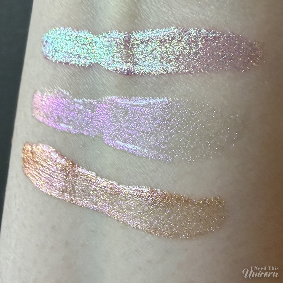 ueen Cosmetics Tester gloss swatches on fair skin showing distinct color shifts: Tester #1 shifts pink to green, Tester #2 reflects lavender and pink, and Tester #3 shifts gold to peach.