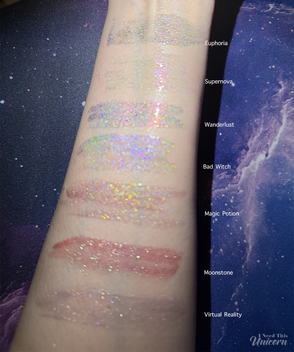 Queen Cosmetics Tester Diamond Shimmer Glosses | I Need This Unicorn Bokeh out-of-focus blurry photo of my personal favorite Queen Cosmetics lip glosses to show the rainbow and duochrome shifts of the glitter and sparkle