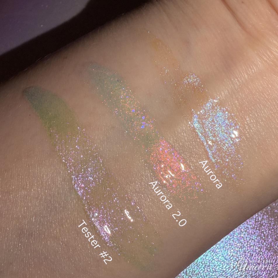 Queen Cosmetics Tester Diamond Shimmer Glosses | I Need This Unicorn Comparison arm swatches of Queen Cosmetics Aurora, Aurora 2.0 and Tester #2 at night with a direct flash from an iPhone.