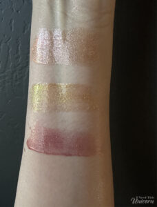 Queen Cosmetics Tester #3, Aphrodite, and Face Time swatches photographed in direct sunlight to show holographic sparkle and duochrome effects.