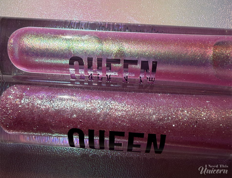 Queen Cosmetics Tester Diamond Shimmer Glosses | I Need This Unicorn Close-up comparison of Queen Cosmetics Tester #1 and Moonstone glosses, showing Tester #1's stronger duochrome shift and Moonstone's more glittery appearance in the tube.