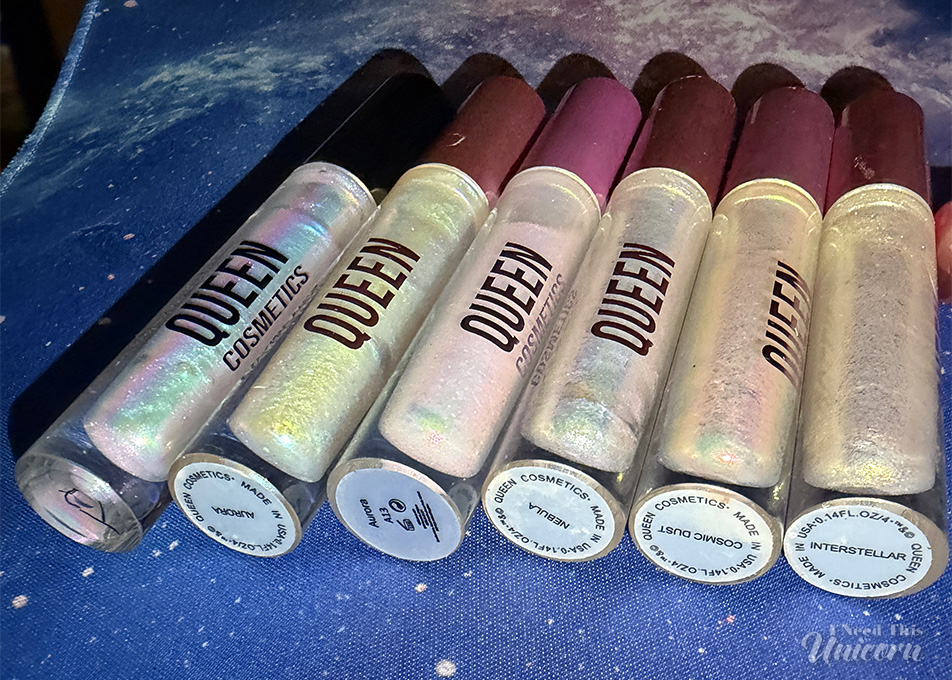 Queen Cosmetics Tester Diamond Shimmer Glosses | I Need This Unicorn Queen Cosmetics Tester #2 photographed with the Stardom Collection for comparison. While Tester #2 features an opalescent lavender-pink shimmer, the Stardom glosses display a range of blue, pink, green, peach, and gold color shifts.
