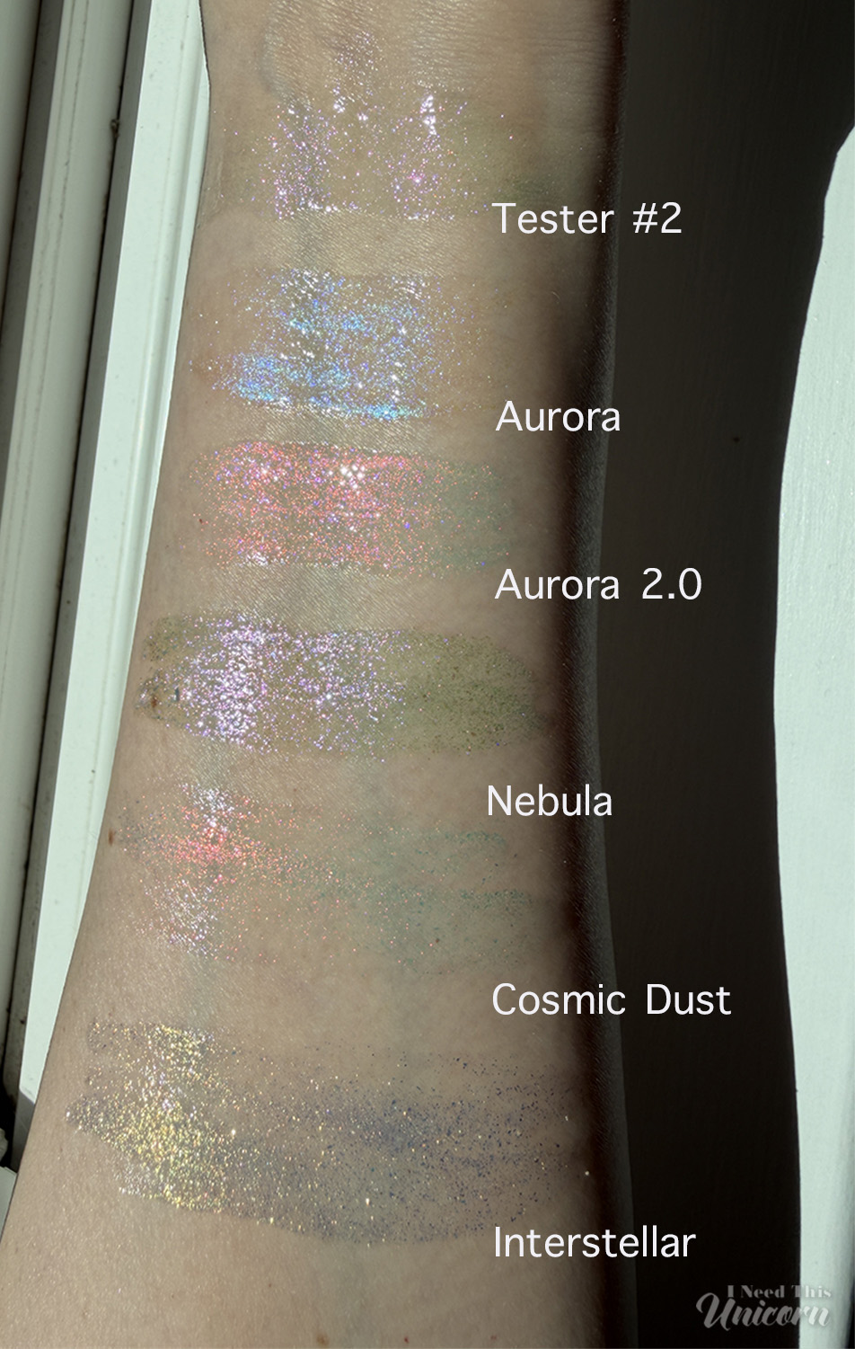 Queen Cosmetics Tester Diamond Shimmer Glosses | I Need This Unicorn Sunlight swatches comparing Queen Cosmetics Tester #2 with Aurora, Aurora 2.0, Nebula, Cosmic Dust, and Interstellar from the Stardom Collection, showcasing differences in color shifts, sparkle density, and reflective shimmer in the sunlight