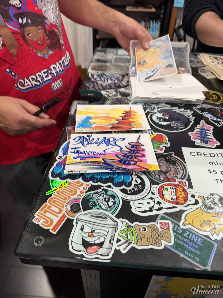 Nate1 showing his illustrations at 3 Pillars in Japantown